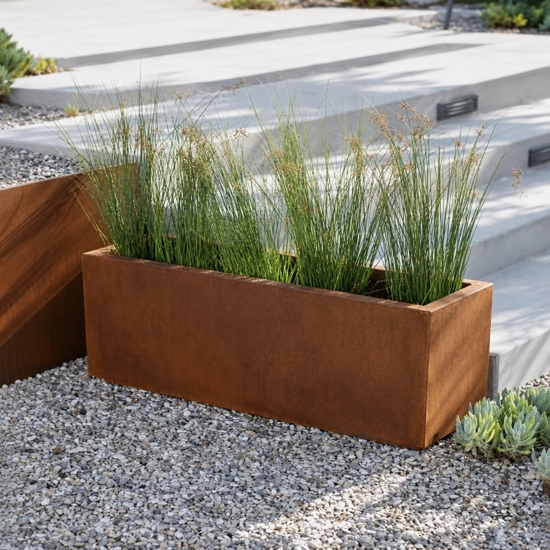 Corten steel rectangular planter box in outdoor garden